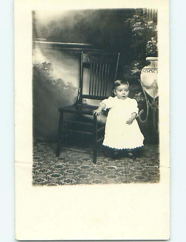 Pre-1918 Damaged rppc CHILD BY ANTIQUE CHAIR Sioux City Iowa IA t2372