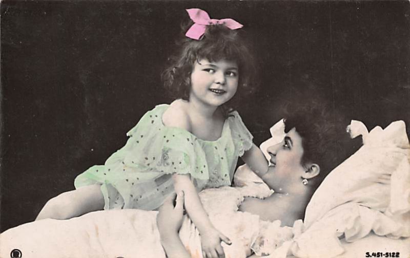 A girl laying beside her mother in bed Writing on Back