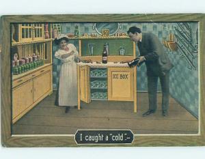 Pre-Linen MAN TAKING BOTTLE FROM ANTIQUE ICE BOX IN KITCHEN HL4318