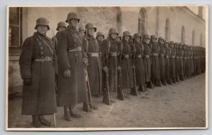 RPPC WW1 Soldiers Long Coats Rifles In Europe Postcard N30