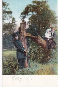 Romantic Couple Sitting In Tree With Policeman Watching