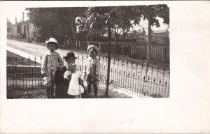 RPPC Darling Children with  Hats Dress Father Iron Fence Yard Scene Postcard Z20