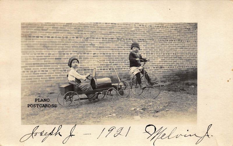 CHILDREN WITH VINTAGE TRICYCLE AND PEDAL CAR RPPC REAL PHOTO POSTCARD