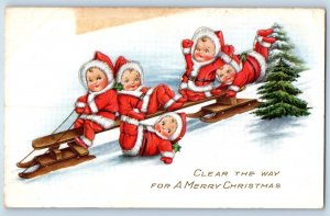 c1910's Christmas Little Fairies Sledding Pine Trees Winter Embossed Postcard