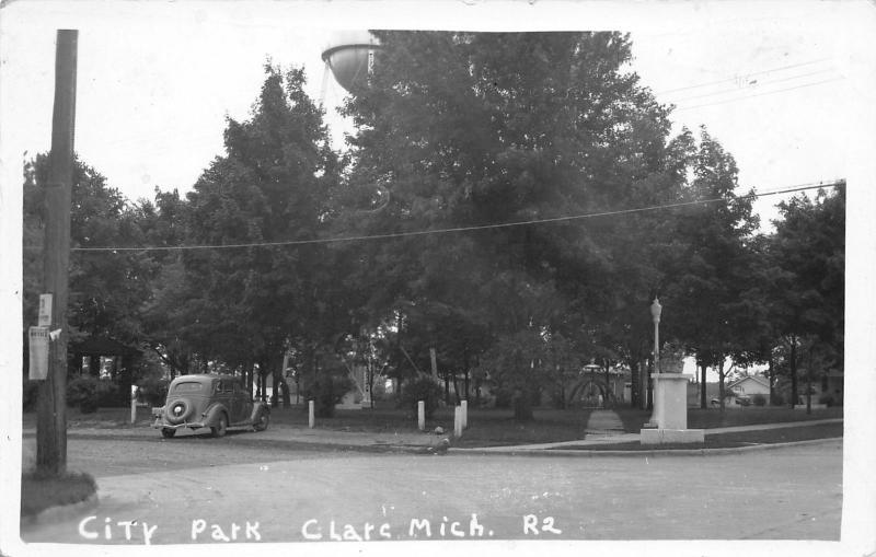 Clare Michigan~Water Tower Over City Park~Notice on Telephone Pole~1930 Car~RPPC