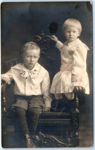 c1910s Cute Siblings RPPC Cute Children Little Boy Girl Wood Chair Postcard A167