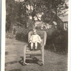 c1910s Cute Little Boy Outdoors RPPC Wicker Chair House Real Photo Postcard A94