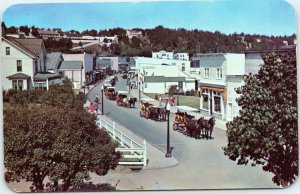 postcard Mackinac Island MI - Main Street and Village - horse-drawn carriages