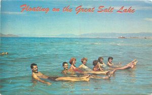 Bonneville News Floating relaxing swimmers Great Salt :Lake Utah Postcard 10404