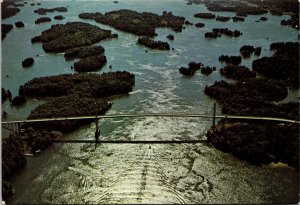 CONTINENTAL SIZE POSTAL CARD AERIAL VIEW THE THOUSAND ISLANDS BRIDGE USA/CANADA