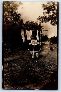 c1910s Little Girl Playing Toy Mower Hanging Clothes RPPC Photo Antique Postcard