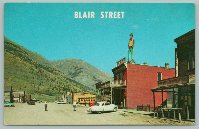 Silverton Colorado~Blair Street~False Front Buildings~Cowboy Billboard~Car~1960s