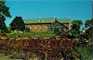 Amana Colonies Iowa Flower Garden Brick Church Village Lutheranism Postcard UNP 