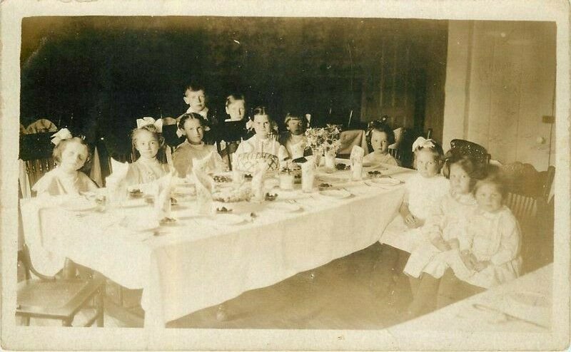 1909 Girls & Boys interior sitting around dinner Table RPPC Postcard 21-10278