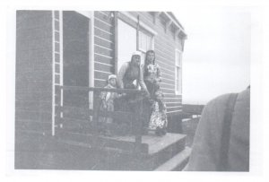 Family stand on porch of home on Marken Isle Netherlands RPPC Postcard
