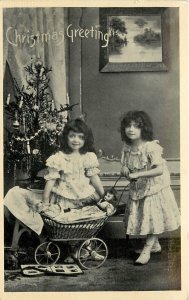 Christmas Greetings Postcard Little Girls With Doll in Perambulator Xmas Tree