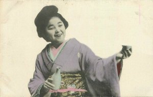 C-1910 Native Dress woman Sake Bottle Japan hand colored Postcard 20-12679