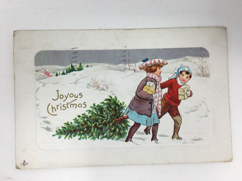 1912 Joyous Christmas Postcard Couple People Pulling Tree Through Snow
