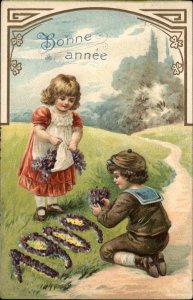 Birthday Little Boy and Girl Flowers Year 1909 Embossed Vintage Postcard