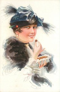 Glamour Postcard, Elegant Smiling Lady in Fancy Hat Eats Chocolates A/S Isaba