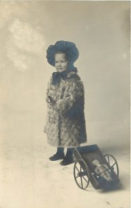 Studio RPPC Postcard Cute Small Girl with her Boy Doll in a Wagon, Unknown US