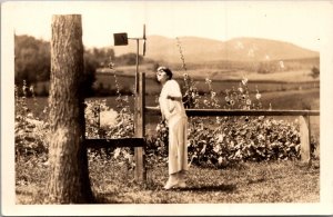 Real Photo Postcard Well Dressed Woman Looking at Wind Spinner in Garden