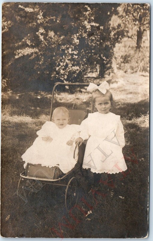 c1910s Adorable RPPC Little Girl w/ Baby Stroller Real Photo Cute Bow Laugh A171