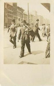REAL PHOTO-STREET SCENE-MEN WALKING ON SIDEWALK-CIRCA 191...