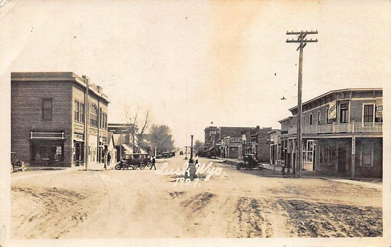 Lusk WY Dirt Street Storefronts Rooming House Old Cars RPPC