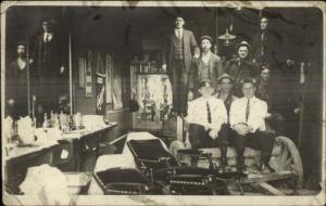 Unusual - Men Sitting on Some Kind of Wagon Inside Barber Shop c1910 RPPC