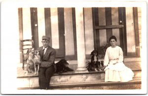 Man Suit with Tie and Woman in White Dress with Four Dogs - Vintage Postcard