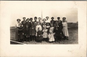 Early Group of Children Young Old Real Photo c1908 Tower in Distance Postcard U5