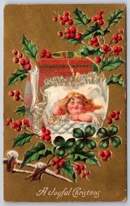 Holiday~A Joyful Christmas~Girl In Bed W/ Clover & Holly~Emb~Vintage Postcard