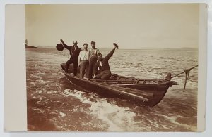 RPPC Four Men in Small Boat being Towed by Rope c1910 Raising Hats Postcard G21