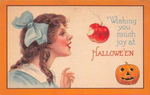 Wishing You Much Joy at Hallowe'en Woman Takes Bite Out Of Apple, Jack-O-Lantern