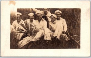 Oddly Posed Group Of Six Men Smiling Portrait Sitting On Grass Postcard