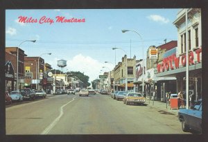 MILES CITY MONTANA DOWNTOWN STREET SCENE OLD CARS STORES VINTAGE POSTCARD