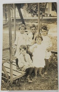 RPPC Sweet Children on Face to Face Swing Appears 5 Siblings c1915 Postcard R3