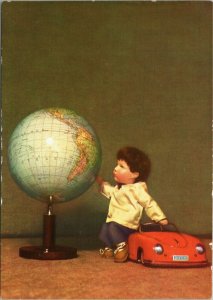 Kathe Kruse - boy doll  leaning on car gazing at globe