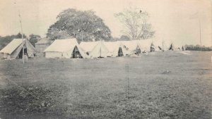 RPPC MILITARY TENT ENCAMPMENT USA FLAG REAL PHOTO POSTCARD (c. 1910)