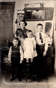 Real Photo Postcard Four Children Inside of a Home