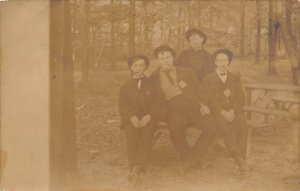 4 Men on a Picnic Bench smoking Real Photo Unused 