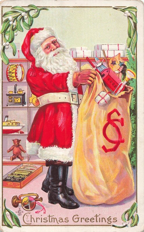 RED SUIT SANTA HOLDS MONOGRAMED BAG FULL OF TOYS~1911 CHRISTMAS POSTCARD