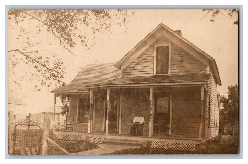 Postcard Old Farmhouse Woman Sitting On Front Porch Vintage Standard View RPPC 