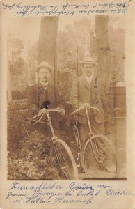 TWO MEN WITH BICYCLES~1910 HEMEUHEIN? GERMANY PSMK REAL PHOTO POSTCARD-