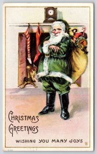 Christmas~Santa in Green Suit in Front of Fireplace~Arms Folded~Embossed~1916