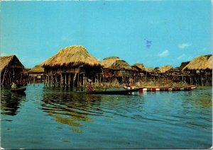 VINTAGE CONTINENTAL SIZE POSTCARD BOATS NEAR INDIGENOUS VILLAGE GANVIE BENIN