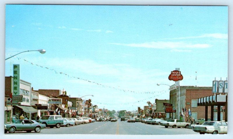 CODY, WY Wyoming ~ SHERIDAN STREET Scene Irma Hotel c1960s Cars Postcard
