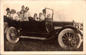 Real Photo Postcard Children, Baby, Dog in Early Open Air Automobile, Iowa