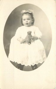 RPPC Vignette Photo Cute Little Girl Holds Monkey Face Stuffed Toy Animal c1910